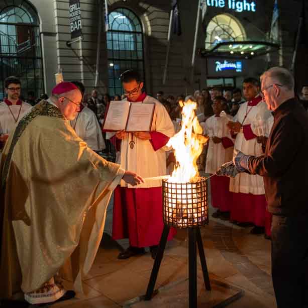 Bishop Marcus light the candle